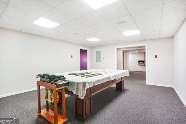 recreation room featuring electric panel, a paneled ceiling, baseboards, and dark carpet