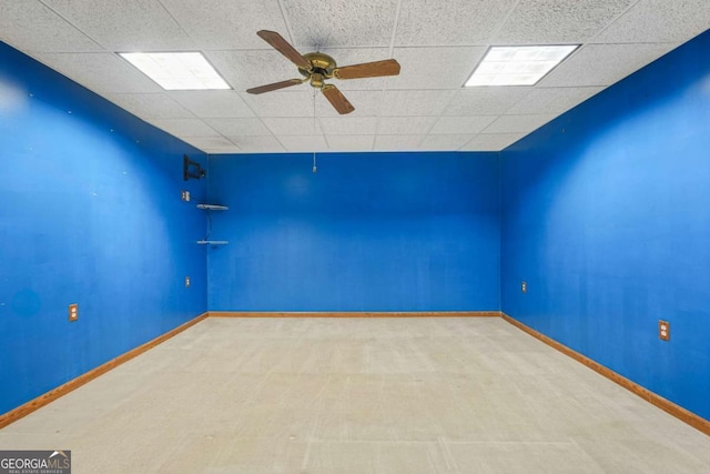 unfurnished room featuring ceiling fan, a paneled ceiling, and baseboards