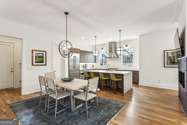 dining space featuring recessed lighting, baseboards, and light wood-type flooring