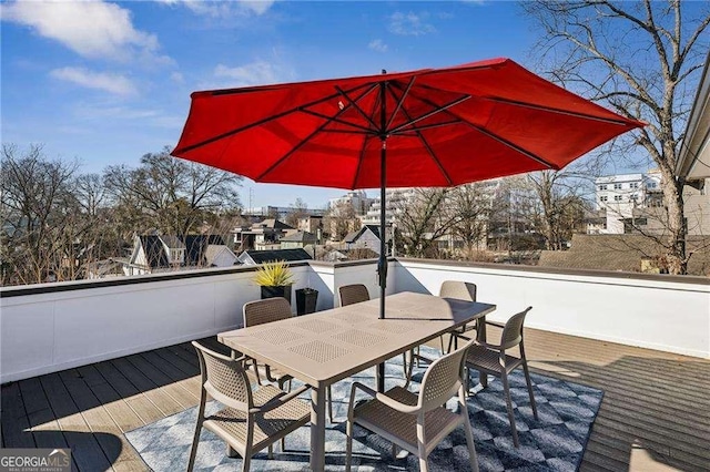 wooden terrace with outdoor dining area