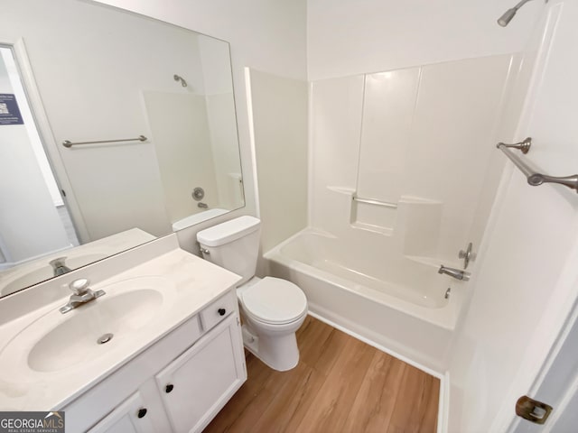 full bathroom with toilet, vanity, shower / bath combination, and wood finished floors