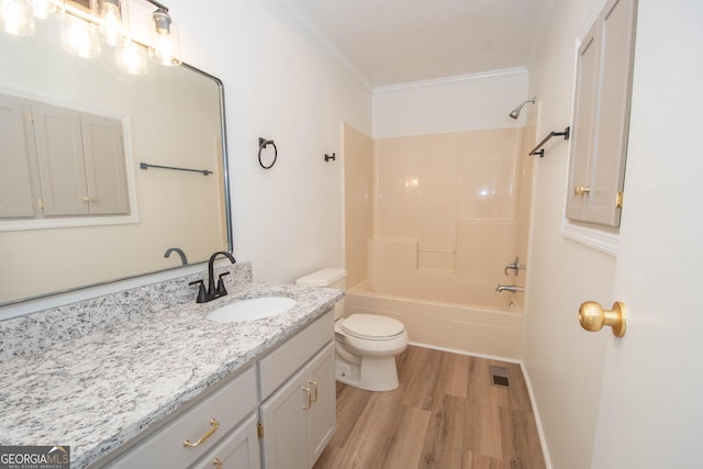 bathroom with vanity, wood finished floors, bathtub / shower combination, crown molding, and toilet