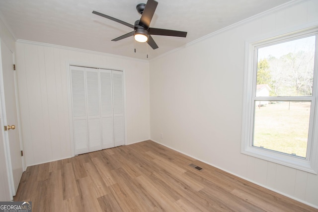 189 Tatum Heights Dr, Lagrange, GA 30240 - unfurnished bedroom featuring a closet, ornamental molding, visible vents, light wood finished floors, and ceiling fan