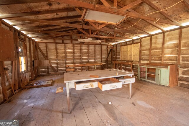 misc room featuring vaulted ceiling and wood-type flooring