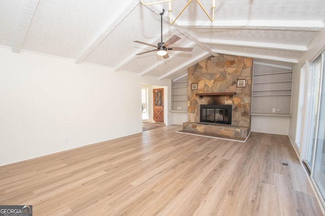 189 Tatum Heights Dr, Lagrange, GA 30240 - unfurnished living room featuring wood finished floors, a healthy amount of sunlight, built in features, a ceiling fan, and vaulted ceiling with beams