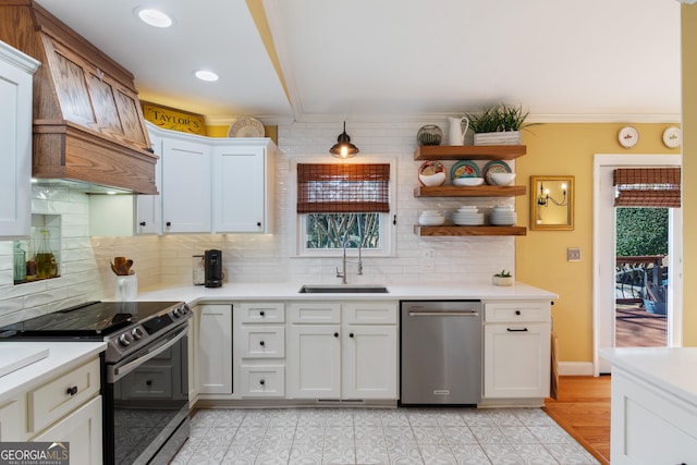 kitchen featuring open shelves, electric range, a sink, custom range hood, and stainless steel dishwasher