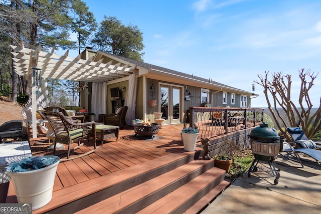 wooden terrace with an outdoor living space with a fire pit, french doors, a pergola, and a grill