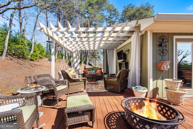 deck with an outdoor living space with a fire pit and a pergola