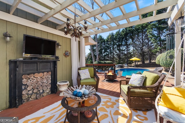 wooden terrace with an outdoor pool, an outdoor living space with a fire pit, and a pergola