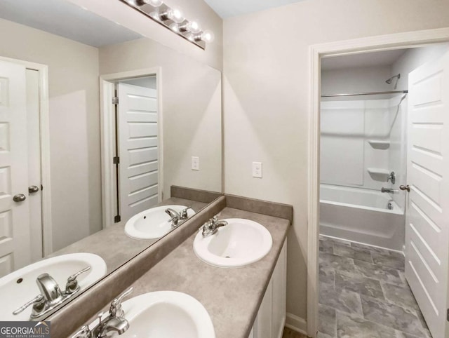 7644 Watson Cir, Locust Grove, GA 30248 - full bathroom featuring double vanity, shower / washtub combination, and stone finish flooring