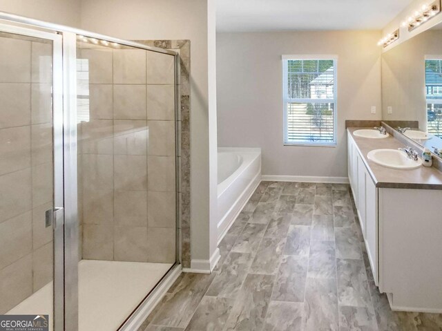 7644 Watson Cir, Locust Grove, GA 30248 - bathroom with double vanity, a bath, and a shower stall
