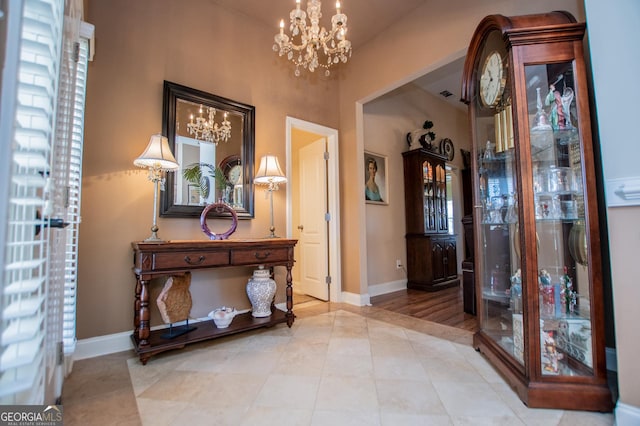 348 N Ridge Ln, Temple, GA 30179 - tiled foyer entrance featuring baseboards and a notable chandelier