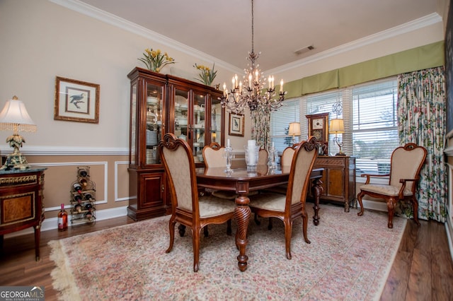 dining area featuring visible vents, wood finished floors, and crown molding