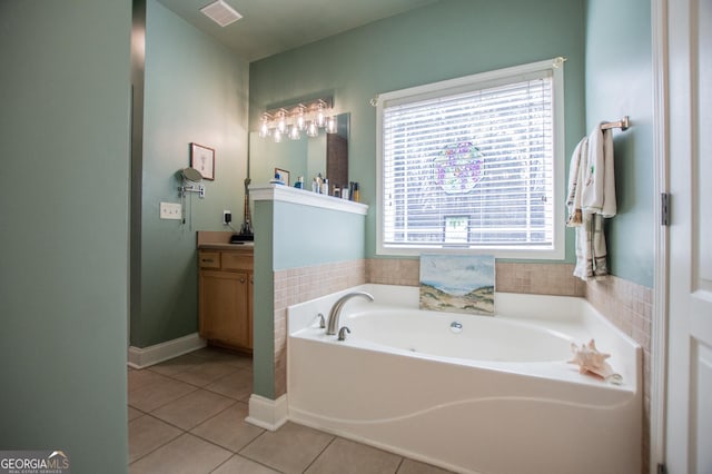 full bath featuring tile patterned flooring, visible vents, vanity, and a garden tub