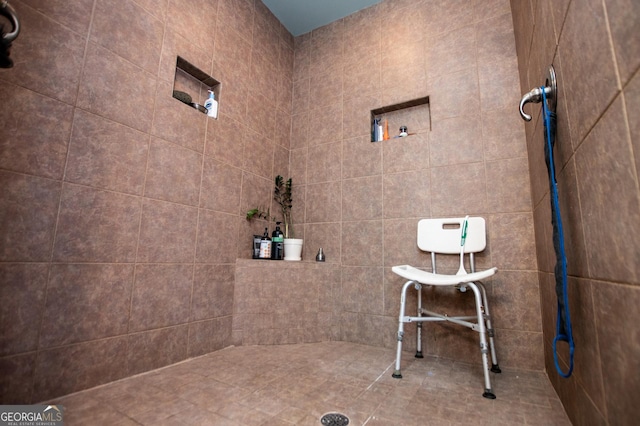 full bath with a tile shower