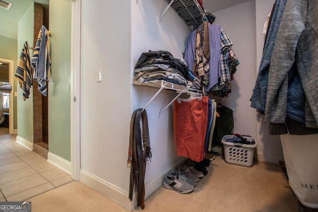 walk in closet with tile patterned floors, visible vents, and carpet floors