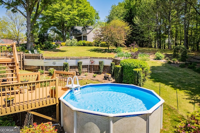 348 N Ridge Ln, Temple, GA 30179 - view of pool featuring fence, a wooden deck, and a lawn