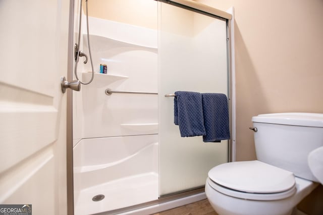 full bath with a shower stall and toilet