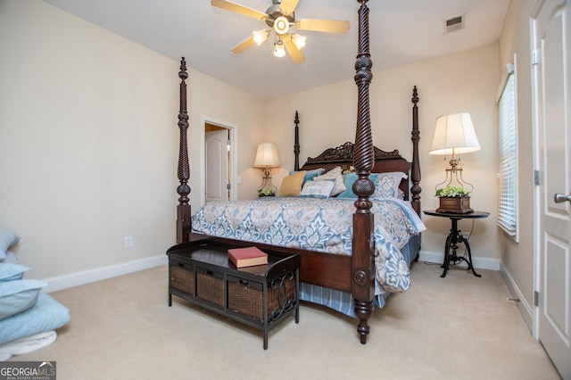 carpeted bedroom with visible vents, a ceiling fan, and baseboards