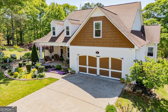 348 N Ridge Ln, Temple, GA 30179 - view of front of house featuring board and batten siding, a shingled roof, driveway, and a front yard