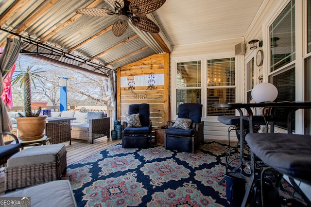 interior space with an outdoor hangout area and a ceiling fan