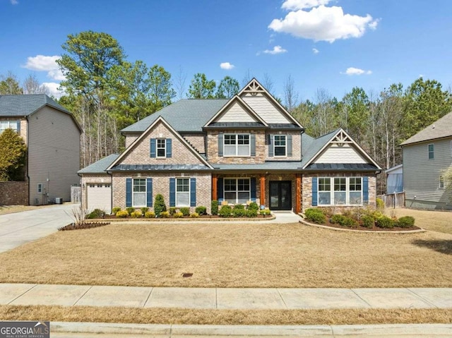 craftsman inspired home with concrete driveway, a garage, and stone siding