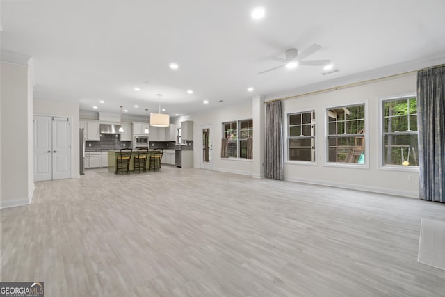 1439 Mill Pointe Ct, Lawrenceville, GA 30043 - unfurnished living room with ornamental molding, ceiling fan, recessed lighting, and light wood finished floors