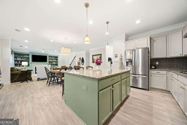 kitchen featuring a center island, crown molding, green cabinets, stainless steel fridge with ice dispenser, and light wood-style flooring