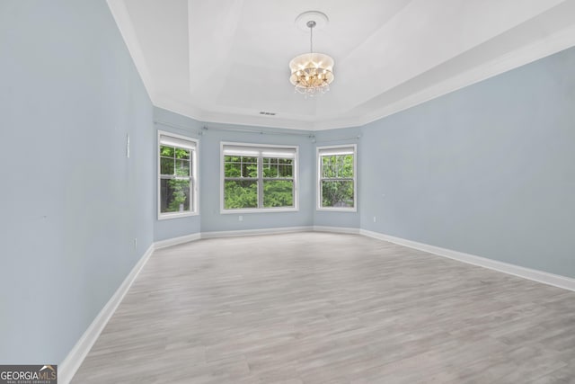 1439 Mill Pointe Ct, Lawrenceville, GA 30043 - empty room featuring a chandelier, a tray ceiling, and light wood-style flooring