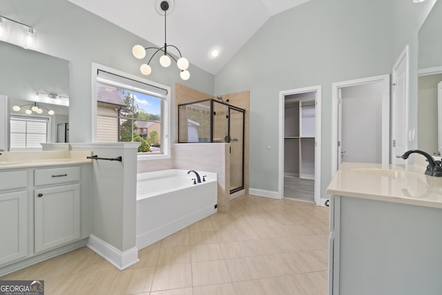 1439 Mill Pointe Ct, Lawrenceville, GA 30043 - full bath featuring a stall shower, a garden tub, plenty of natural light, two vanities, and high vaulted ceiling