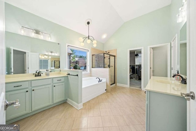 full bathroom with a garden tub, a stall shower, lofted ceiling, and a sink