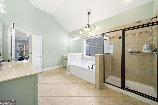 bathroom with a shower stall, vanity, a garden tub, and vaulted ceiling