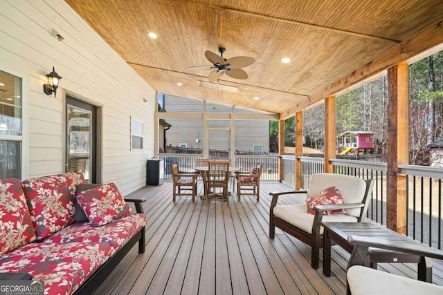 wooden deck featuring an outdoor living space, outdoor dining space, and a ceiling fan