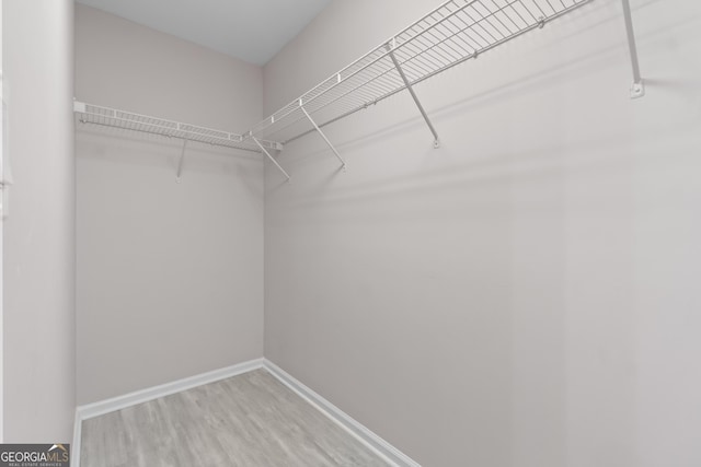 1439 Mill Pointe Ct, Lawrenceville, GA 30043 - walk in closet featuring wood finished floors