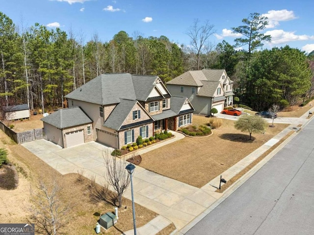 view of front facade with a garage, driveway, and roof with shingles