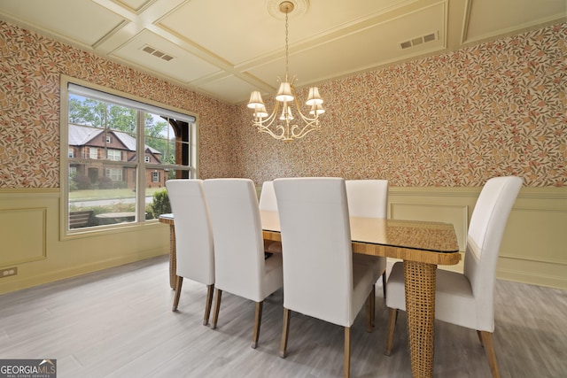 1439 Mill Pointe Ct, Lawrenceville, GA 30043 - dining space with wallpapered walls, a chandelier, a wainscoted wall, and light wood-style flooring