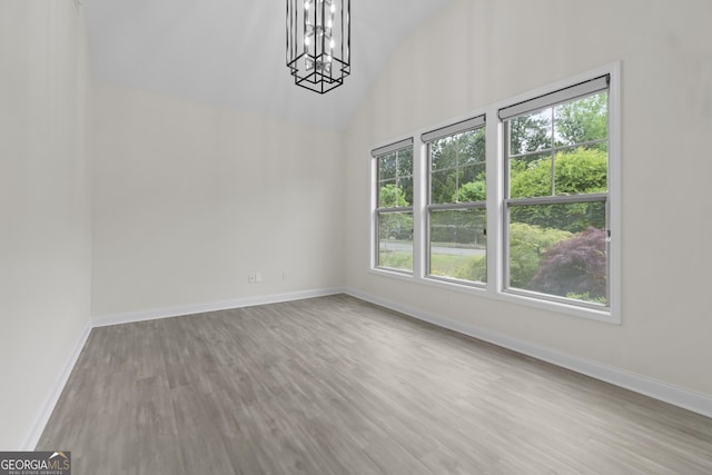 1439 Mill Pointe Ct, Lawrenceville, GA 30043 - unfurnished dining area with a chandelier, wood finished floors, and high vaulted ceiling