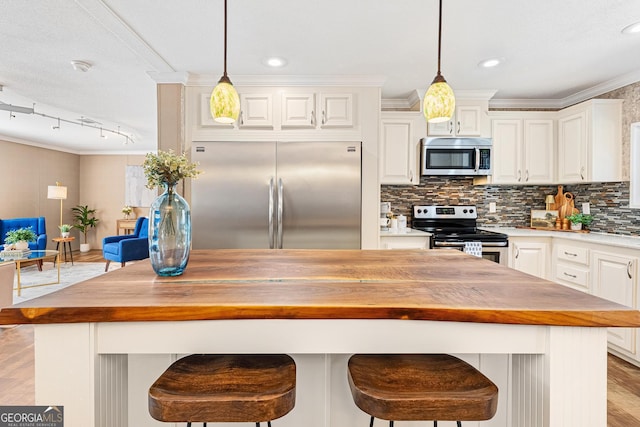 kitchen with stainless steel appliances, wooden counters, ornamental molding, and decorative backsplash