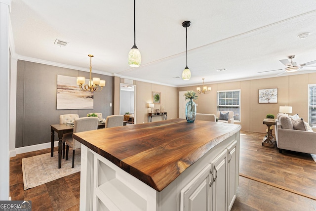 kitchen featuring visible vents, butcher block countertops, ceiling fan with notable chandelier, open floor plan, and dark wood finished floors