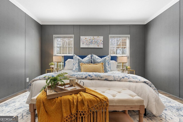 bedroom with crown molding and wood finished floors