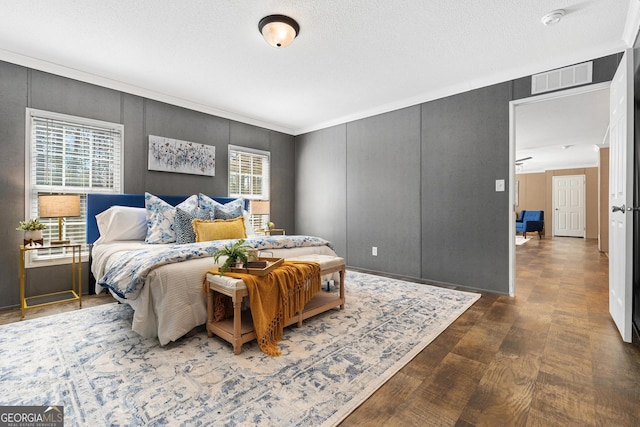 bedroom with visible vents and wood finished floors