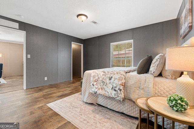 bedroom with visible vents and wood finished floors