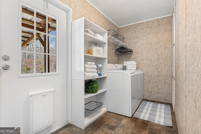 laundry area with laundry area, wallpapered walls, wood finished floors, and separate washer and dryer