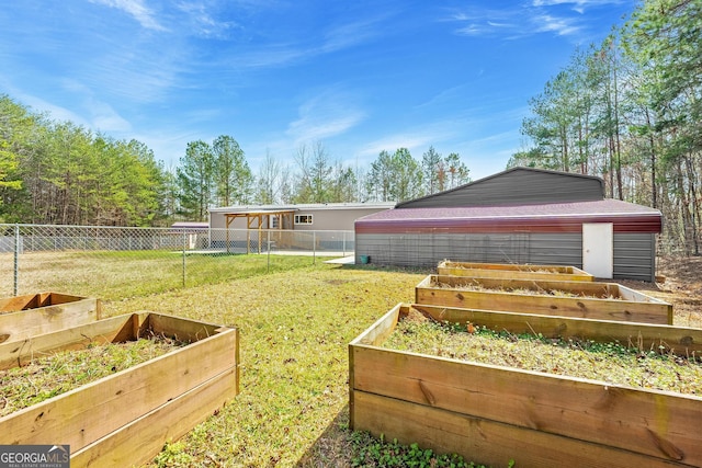 view of yard with a vegetable garden and fence