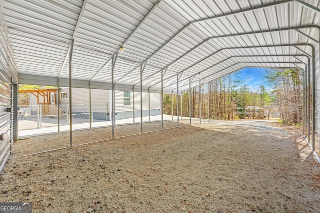 exterior space with a carport and fence