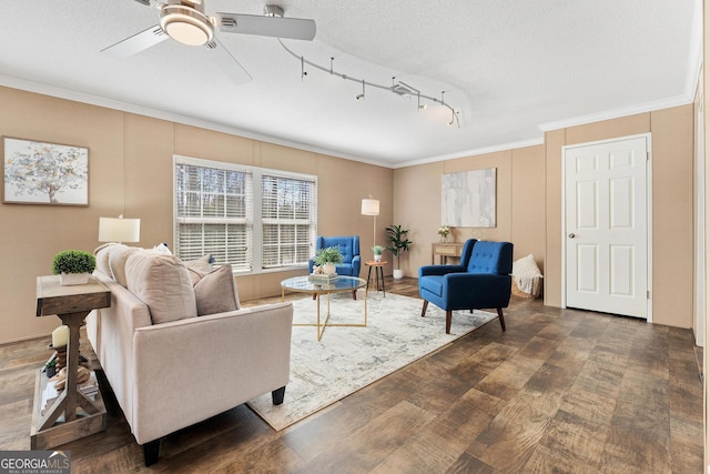 living room with dark wood-style flooring, a textured ceiling, a ceiling fan, and ornamental molding