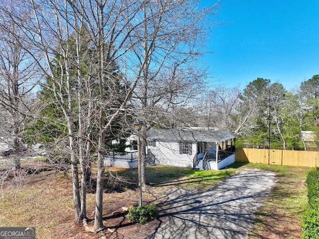 view of front of home with fence and driveway