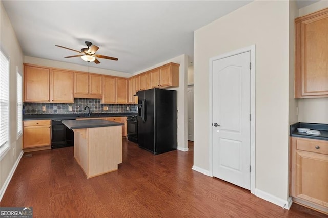 kitchen with dark countertops, black appliances, ceiling fan, and light brown cabinets