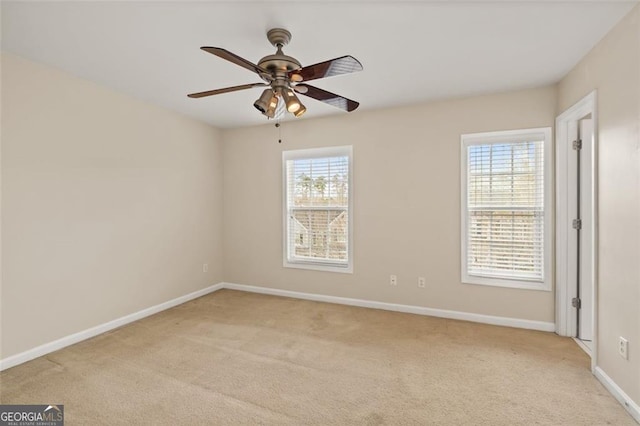 empty room with light carpet, baseboards, and ceiling fan