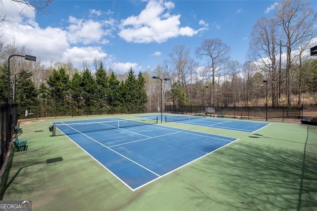 view of tennis court with fence